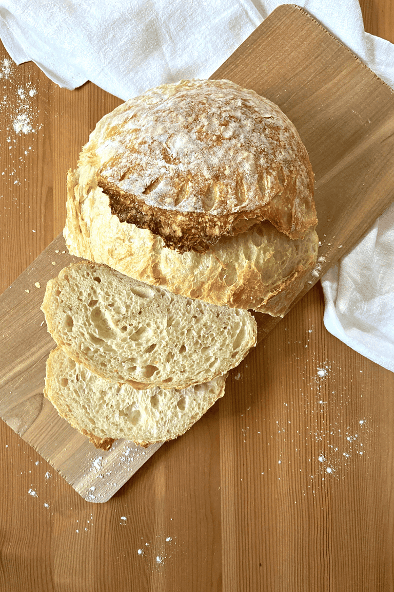 sliced sourdough loaf on a wooden cutting board