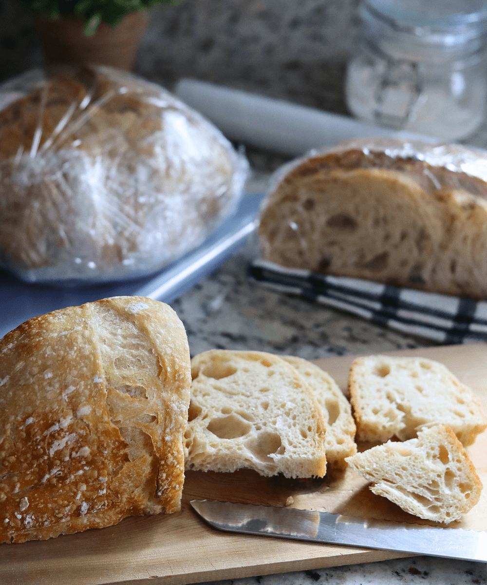 Sliced sourdough bread, sourdough wrapped in plastic wrap.