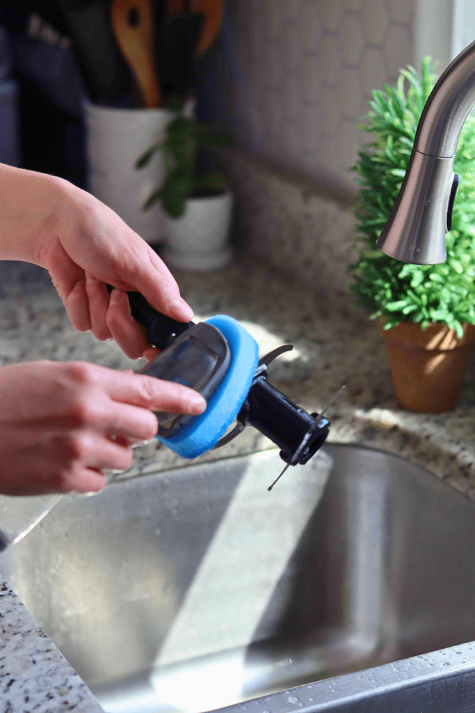 Using a soft sponge with a handle to clean Ninja Blender blade assemblies