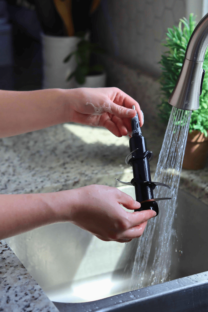 Rinsing Ninja Blender blade assemblies with clean running water