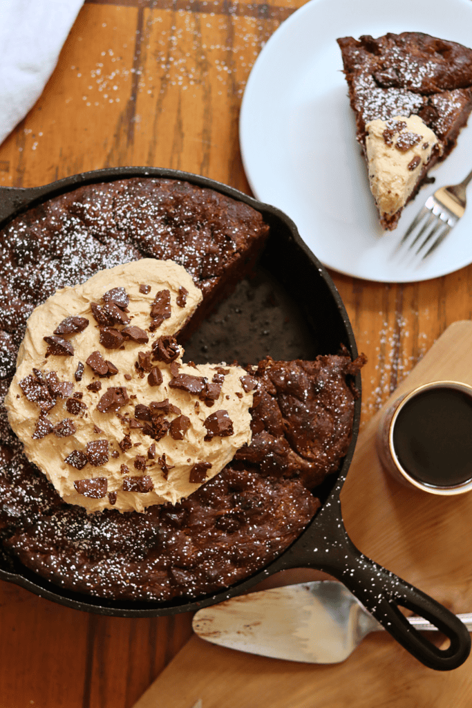 Chocolate Sourdough Focaccia with peanut butter topping and powdered sugar in a cast iron pan