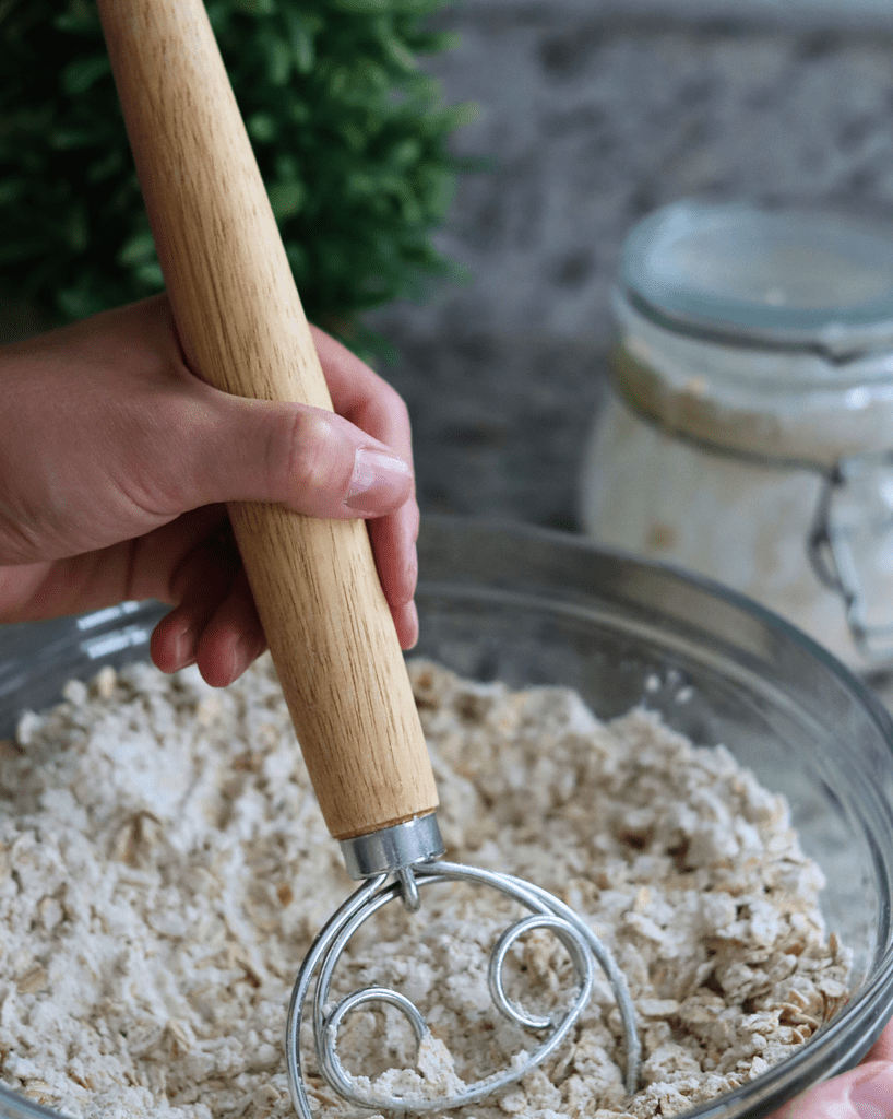 Whisking the dry ingredients in a glass bowl with a Danish Dough whisk