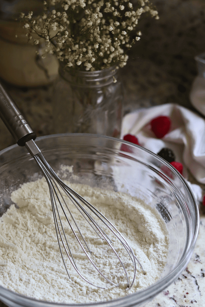 whisking dry ingredients together in a mixing bowl