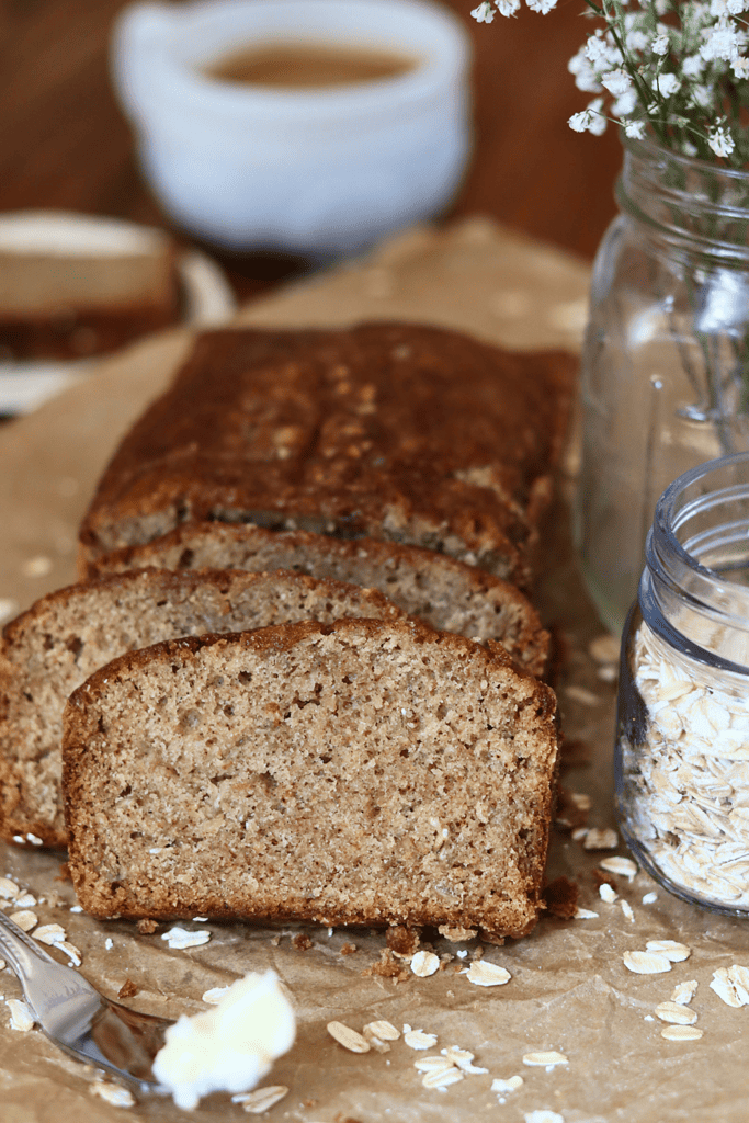 sliced sourdough oatmeal quick bread on parchment paper