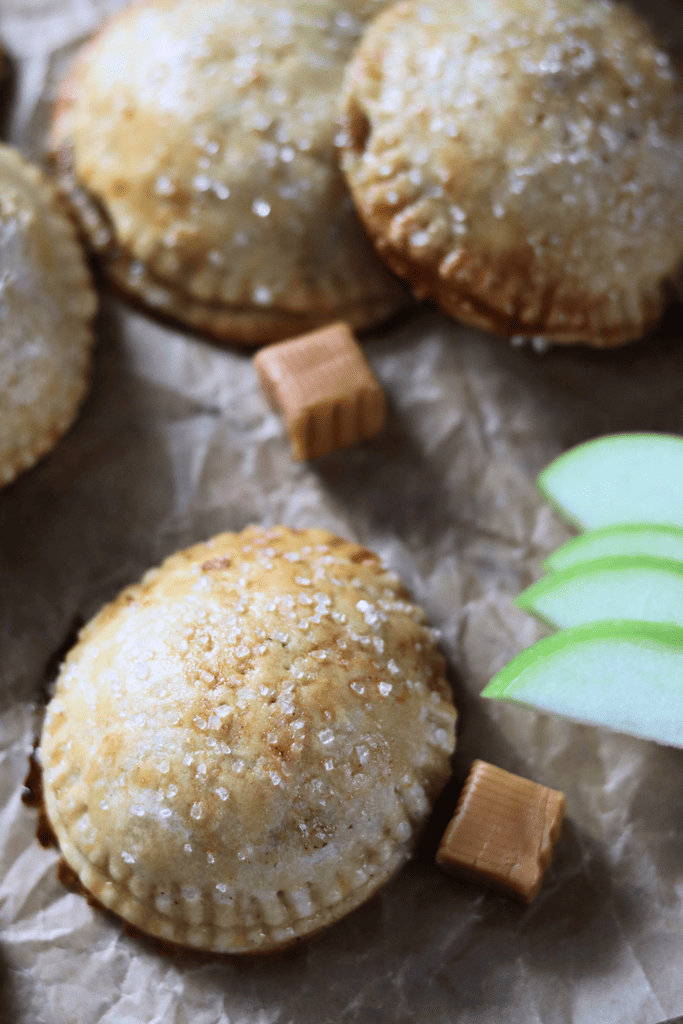 Salted Caramel Apple Sourdough Hand Pies by sliced apples and caramel