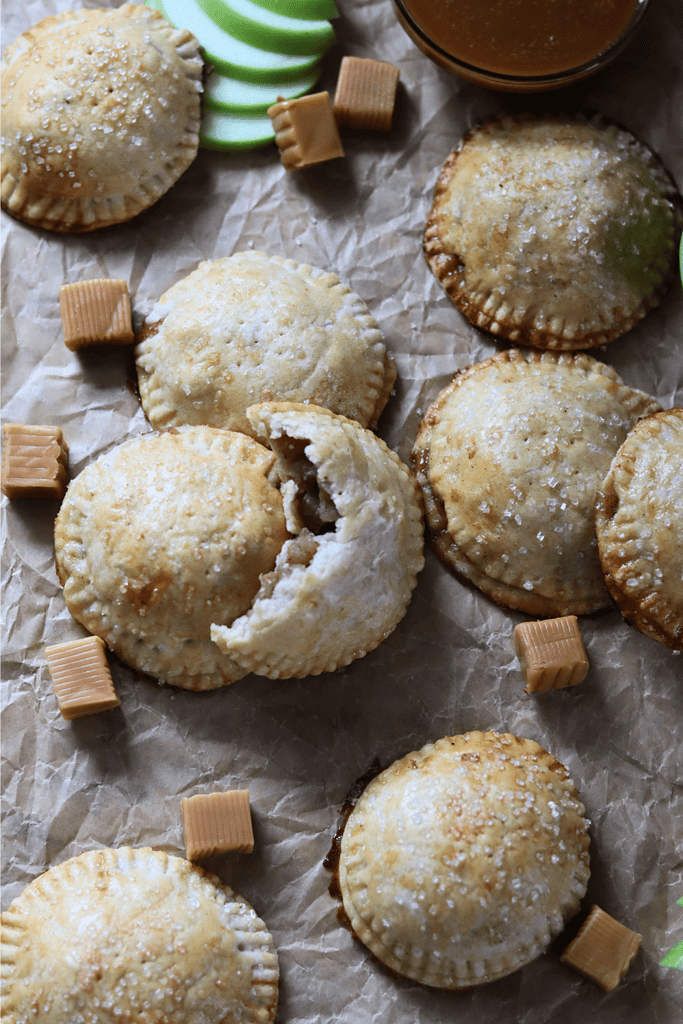 Salted Caramel Apple Sourdough Hand Pies on parchment paper