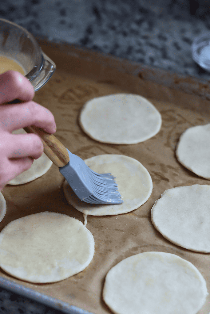 brushing an egg way on the bottom crust