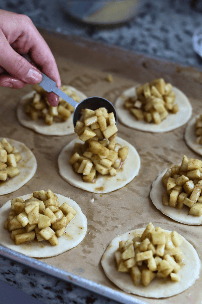 placing apple filling on a pie crust