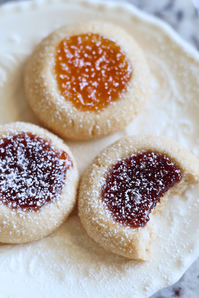 a cookie with a bit out of it with powdered sugar on top