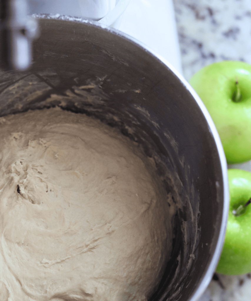 Apple Cider Sourdough Cinnamon Rolls dough in a bowl of a stand mixer