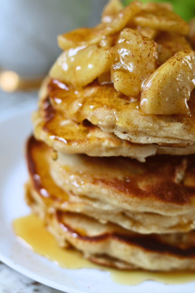 Sourdough Apple Pancakes with sliced apples and maple syrup