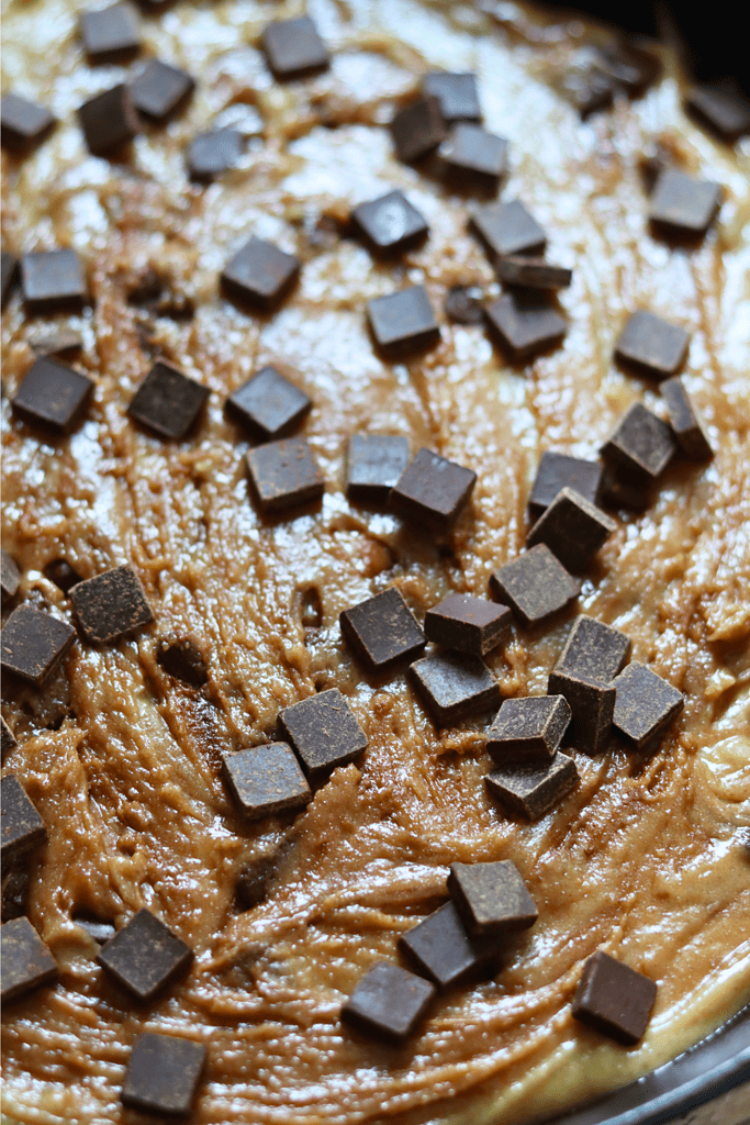 topping the cookie dough with more dark chocolate chunks