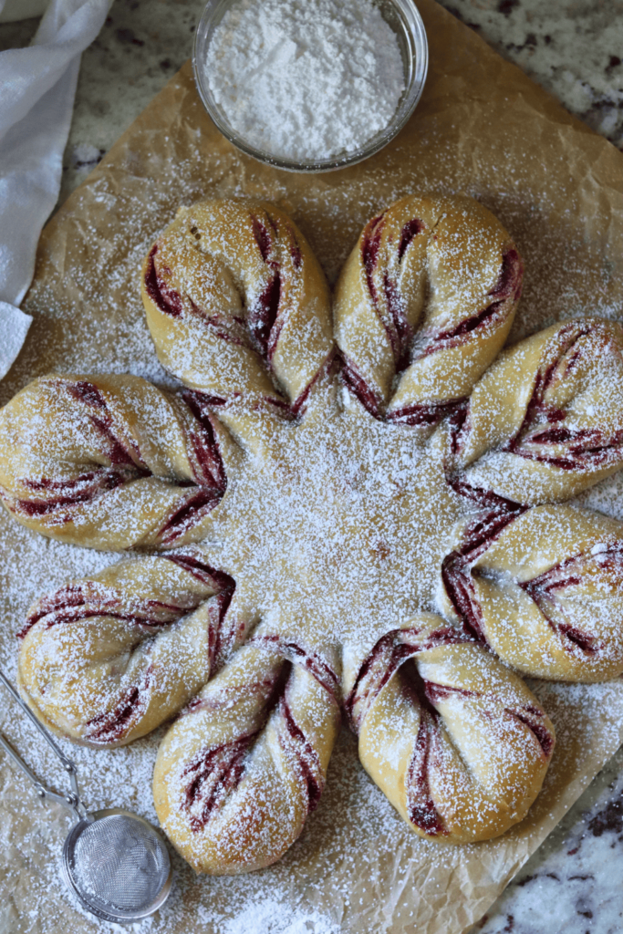 Sourdough Cranberry Orange Star Bread dusted with powdered sugar