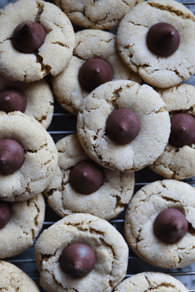 Sourdough Peanut Butter Blossom cookies on a wire rack