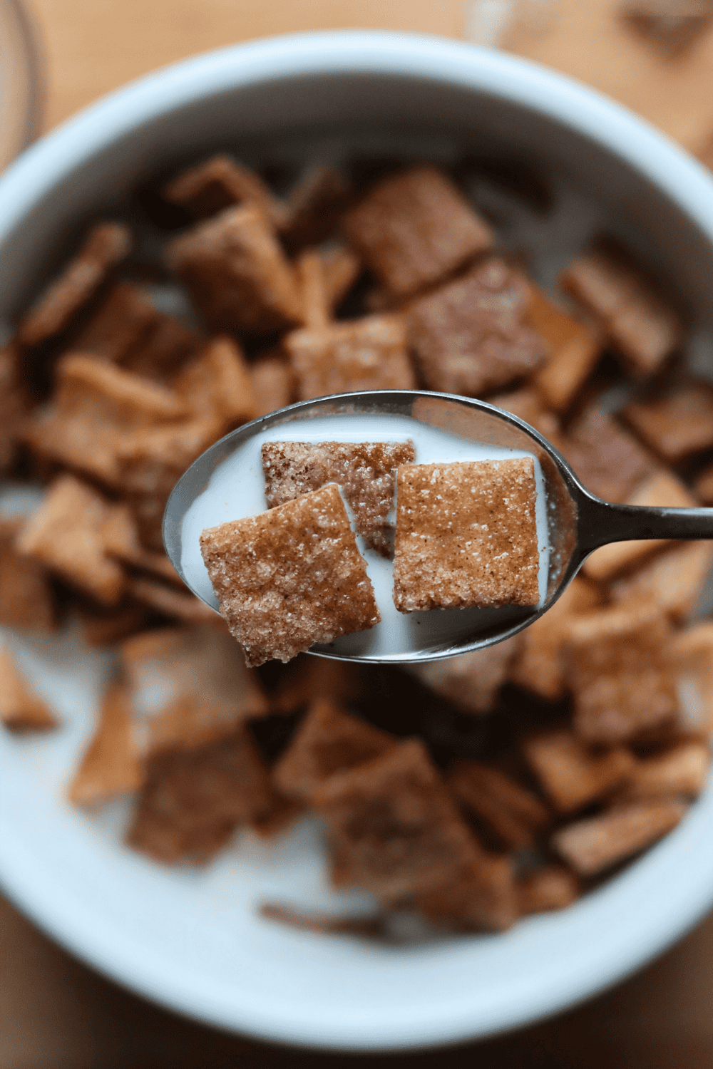 Sourdough Cinnamon Toast Crunch Cereal in a spoon with milk