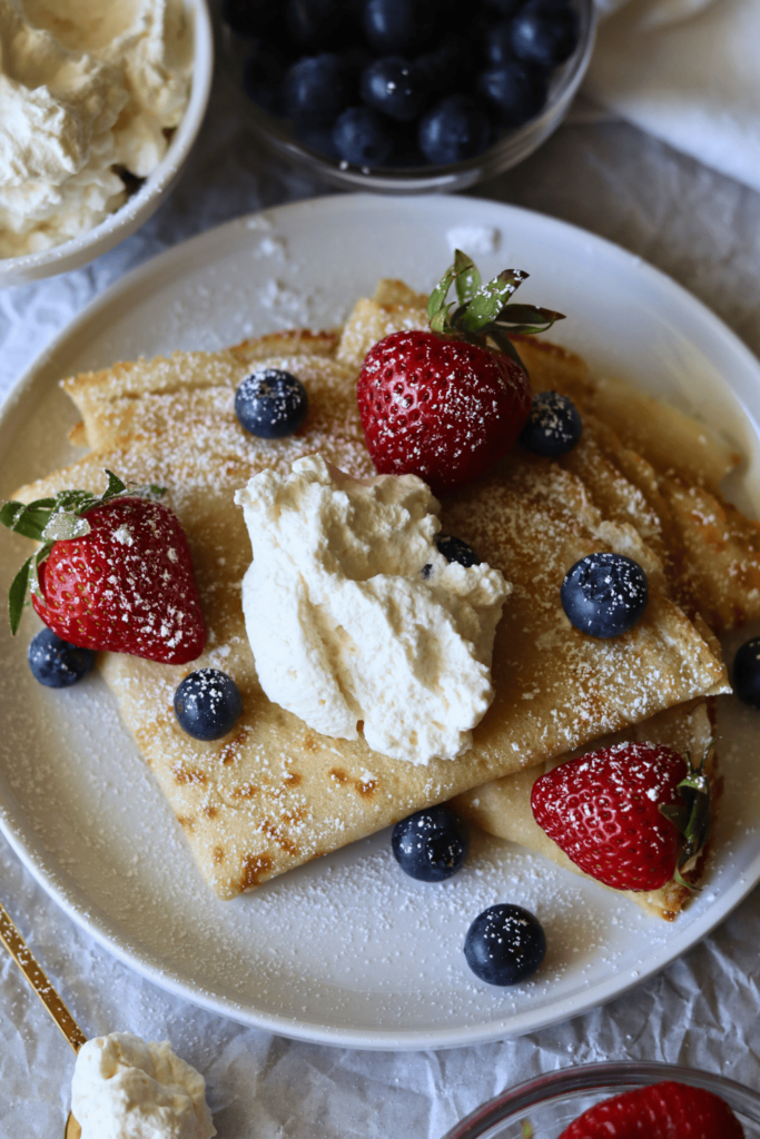 Sourdough Crepes with whipped cream and berries on top