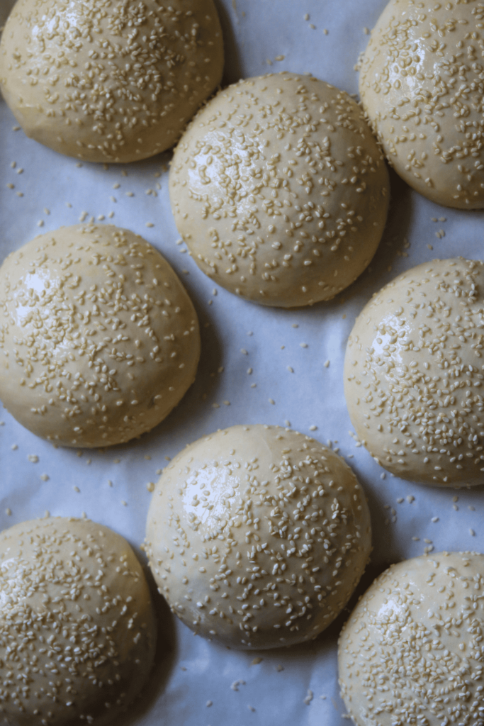 Proofed Sourdough Burger Buns with sesame seeds on top