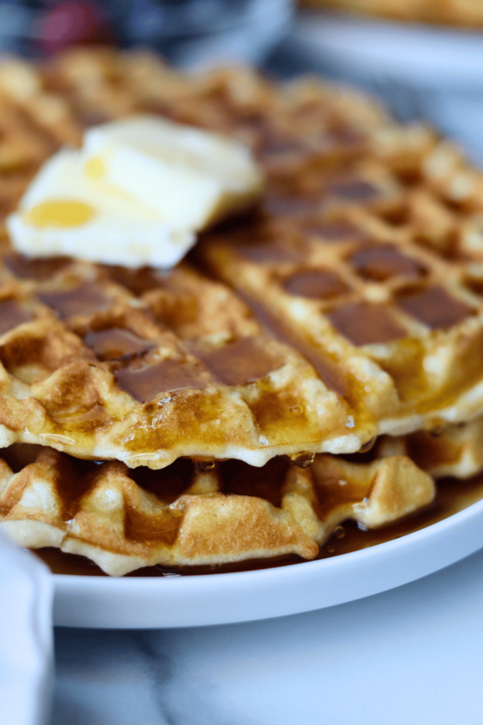 Sourdough Waffles with butter and maple syrup on top