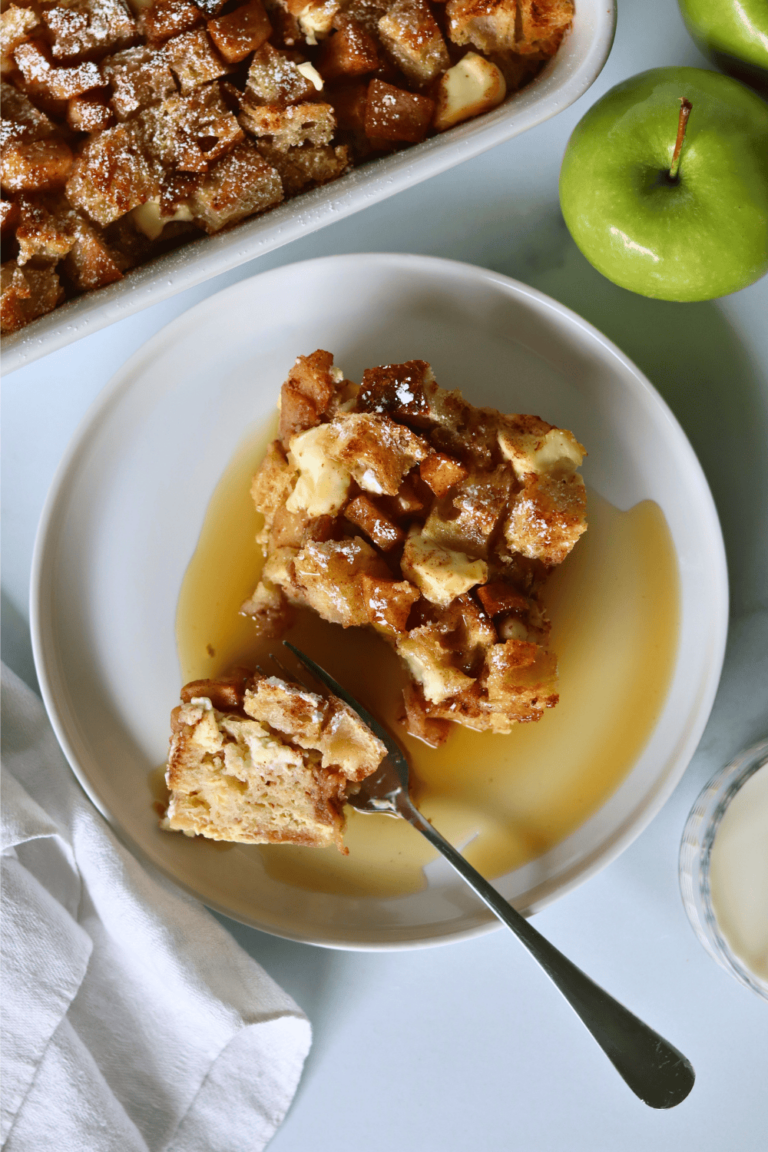 Apple Cinnamon Sourdough French Toast Casserole on a plate with maple syrup