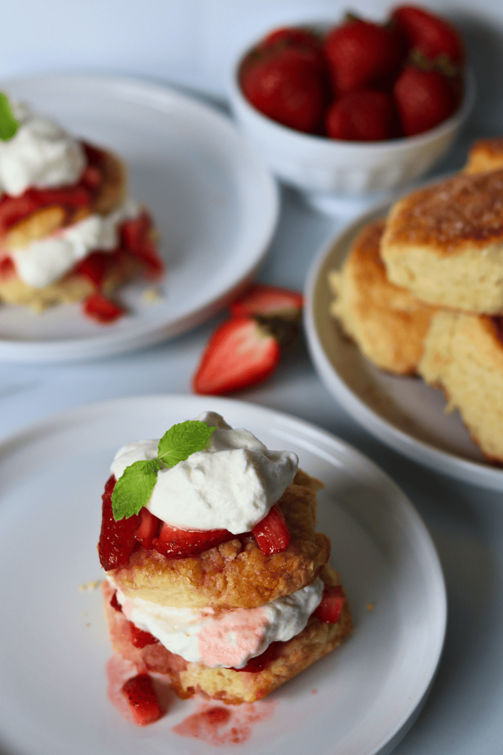 Sourdough Strawberry Shortcakes with a bowl of strawberries