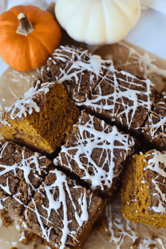 sliced pumpkin coffee cake drizzled with streusel topping