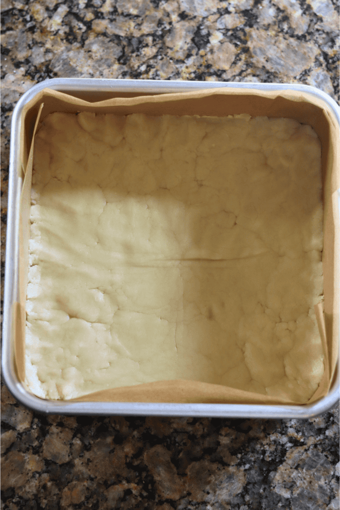 dough in a flattened out on a baking dish
