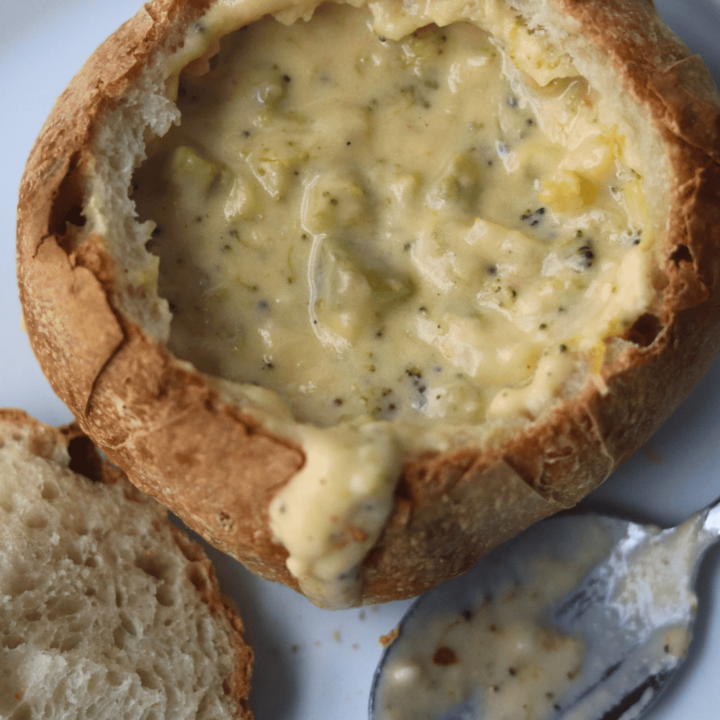 bread bowl with soup and a spoon on the side