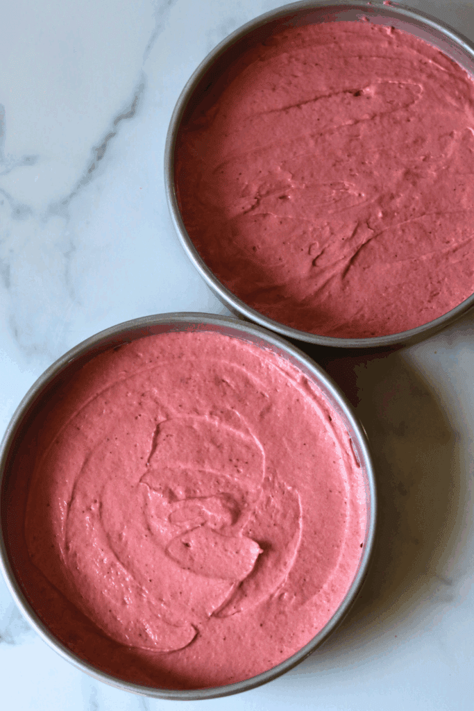 two pans of sourdough strawberry cake batter