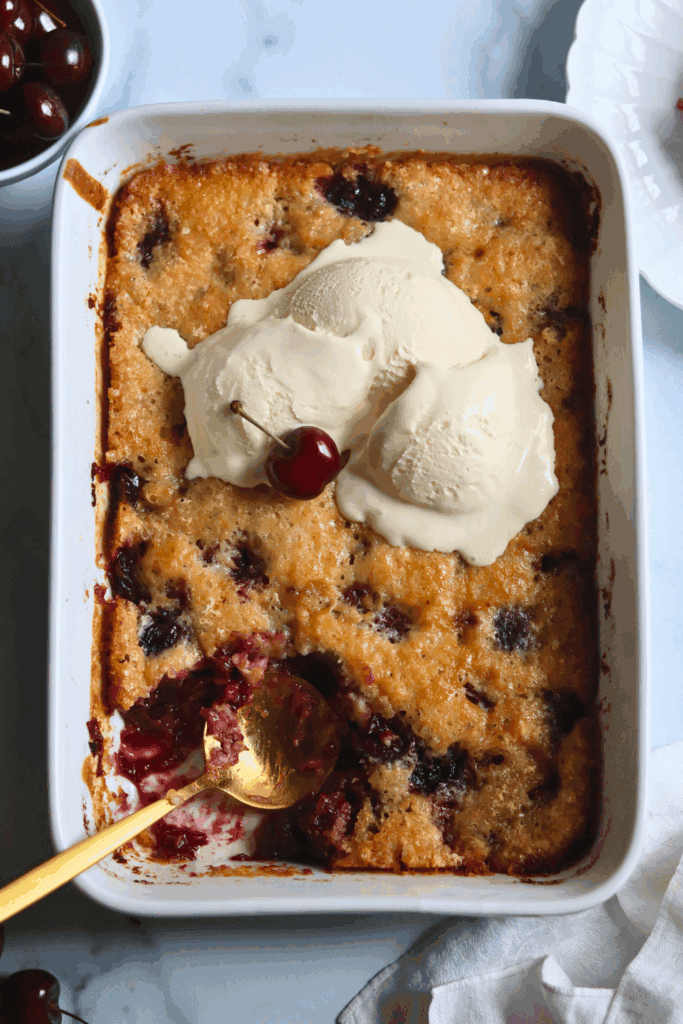 a dish of sourdough cherry cobbler with a slice