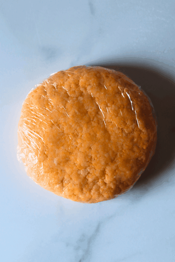 shaped dough with plastic wrap