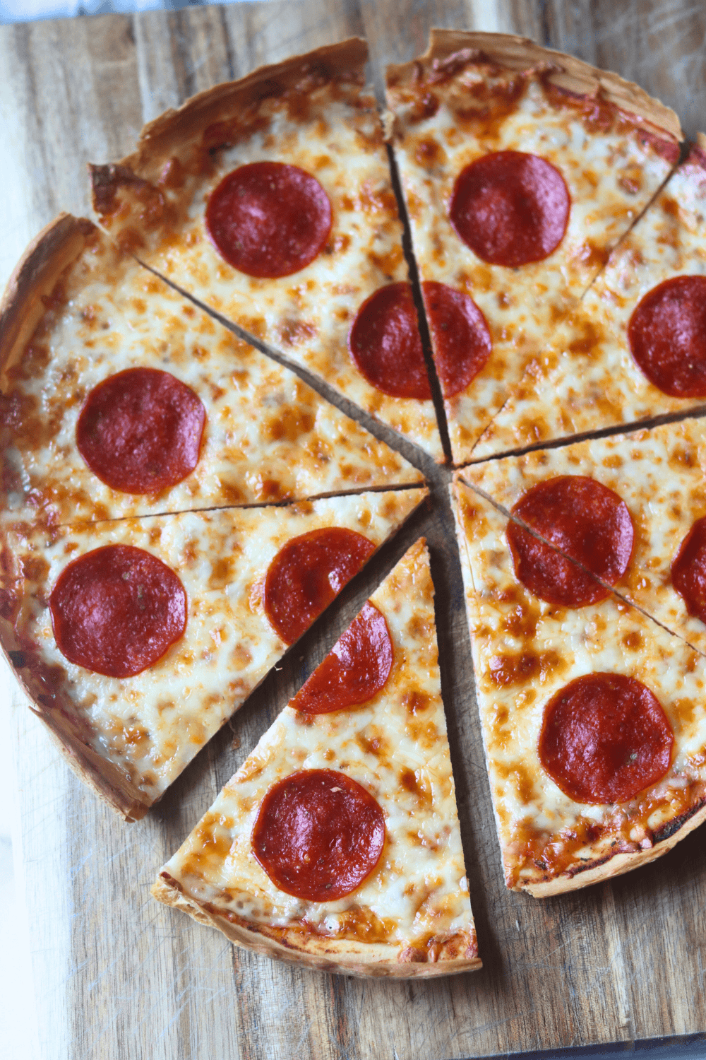 whole pizza divided into pieces