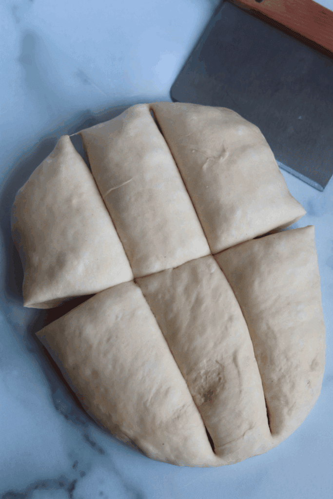 dough divided into 6 equal parts  using a bench scraper