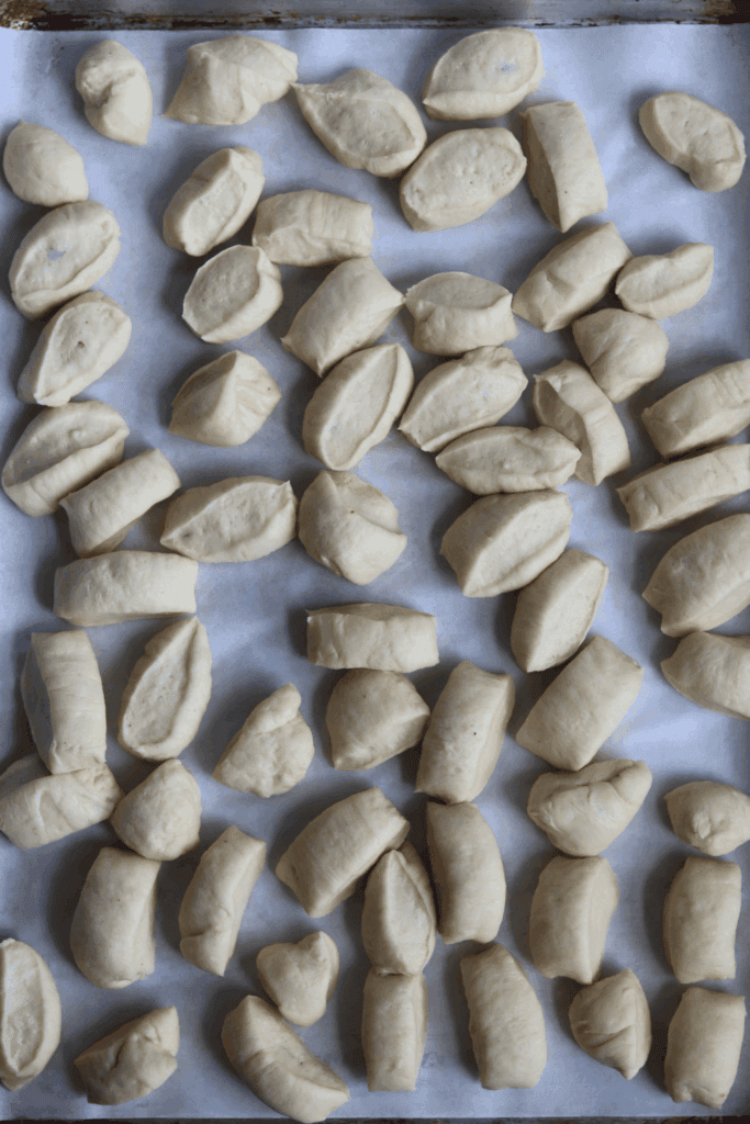 dough cut into pieces in a baking pan