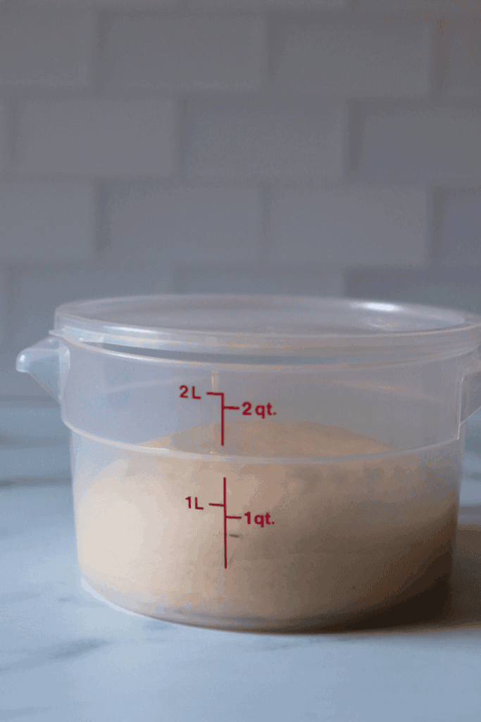 dough placed inside a greased container