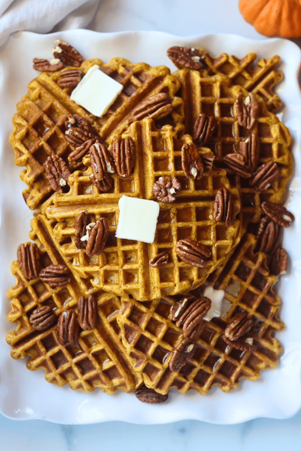 stack of golden waffles on a plate