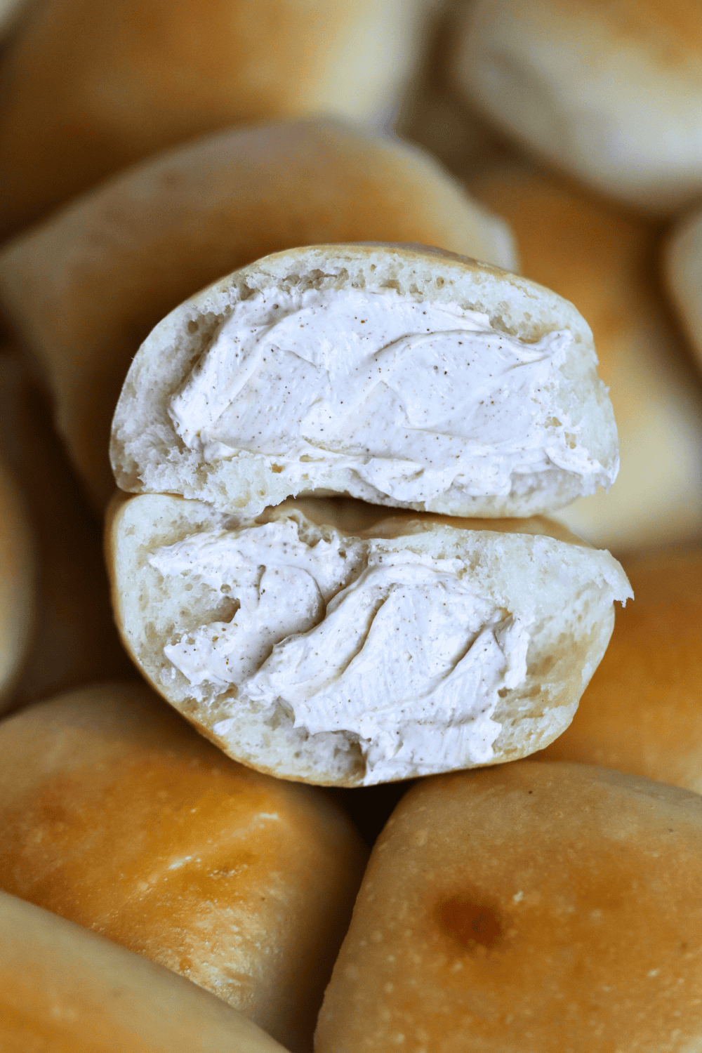sourdough texas roadhouse dinner roll sliced in half and with honey cinnamon spread