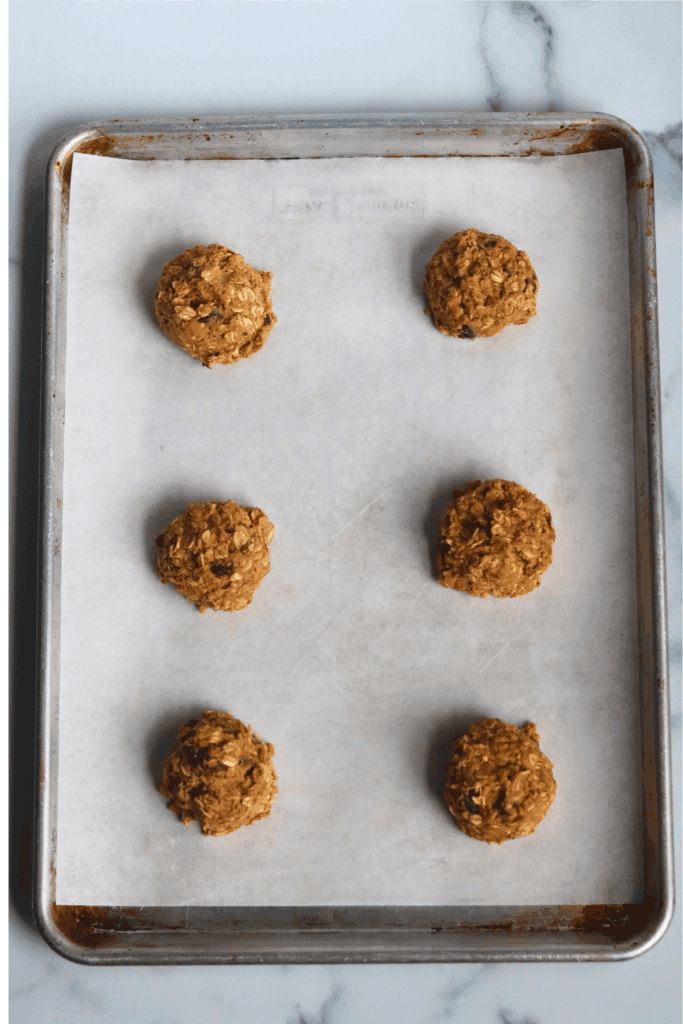 6 oatmeal cookie dough on a parchment paper