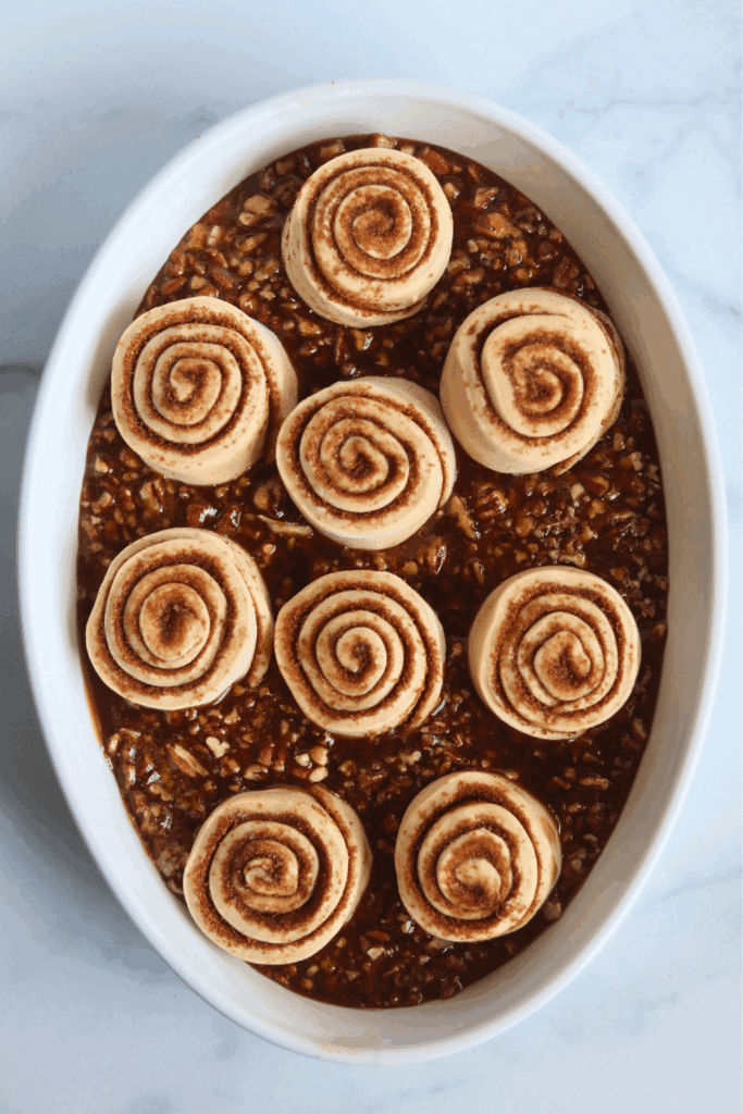 placed rolled cinnamon shaped dough onto the pecan caramel topping