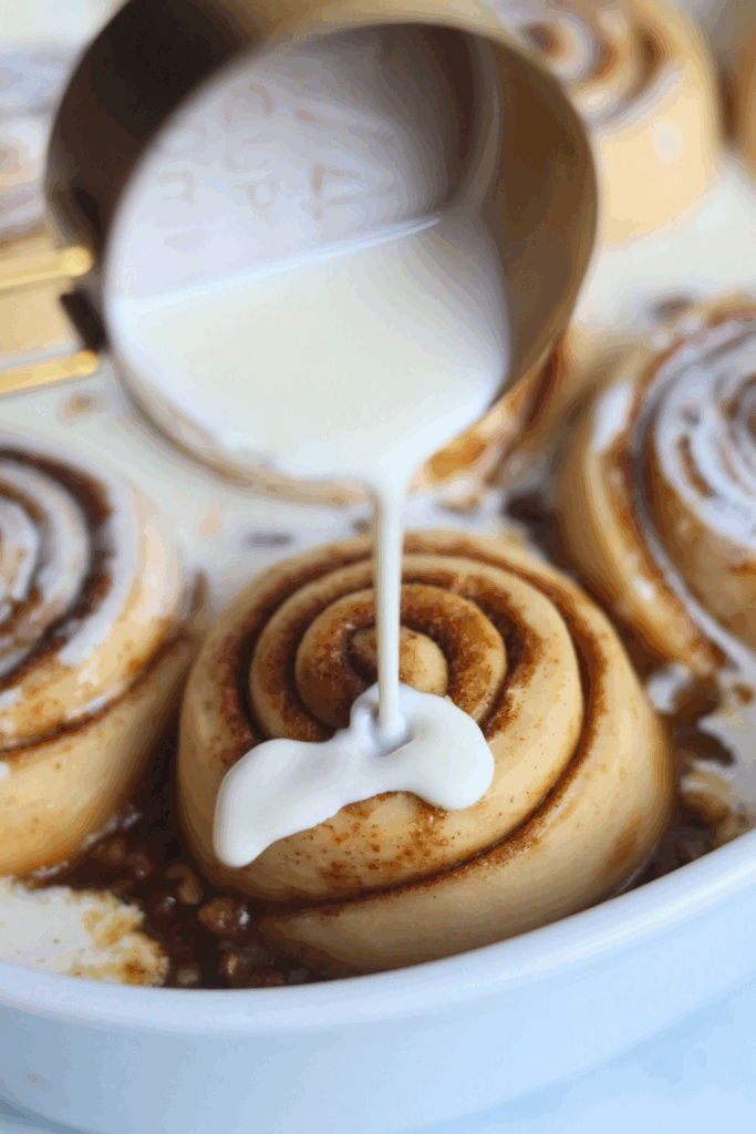 pouring heavy cream on sourdough sticky buns