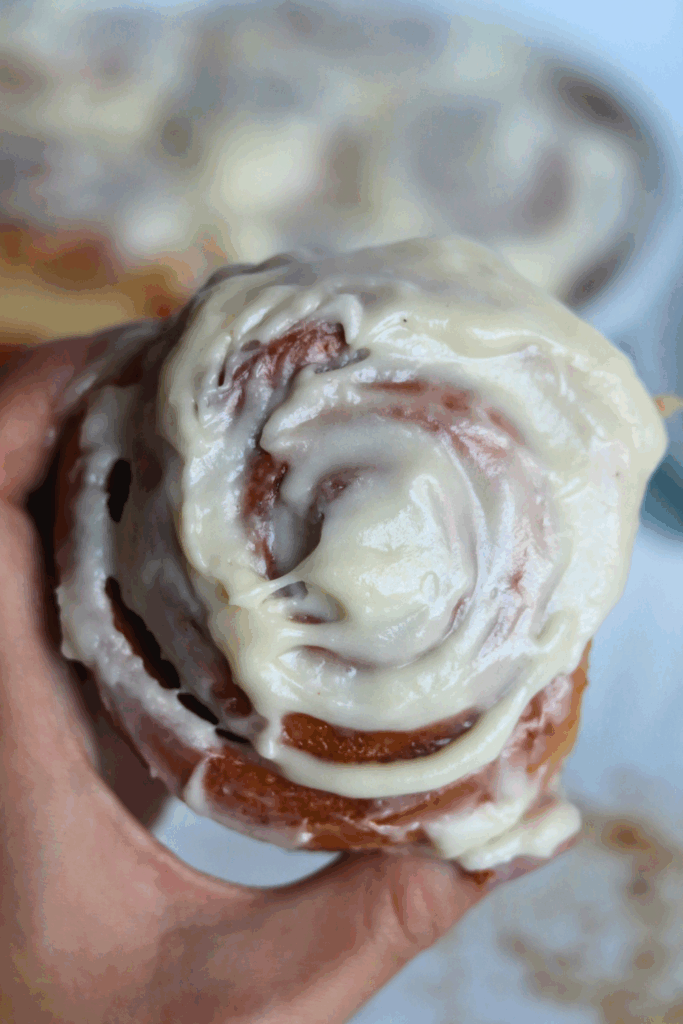 a piece of cinnamon rolls with frosting