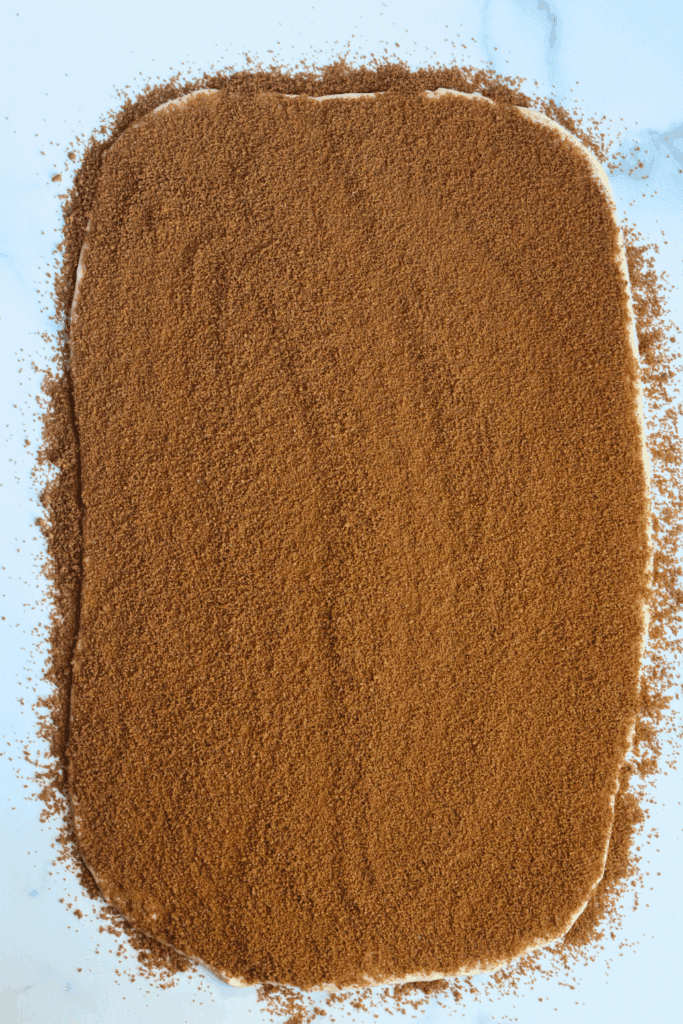 rolled dough spread with sugar and cinnamon mixture