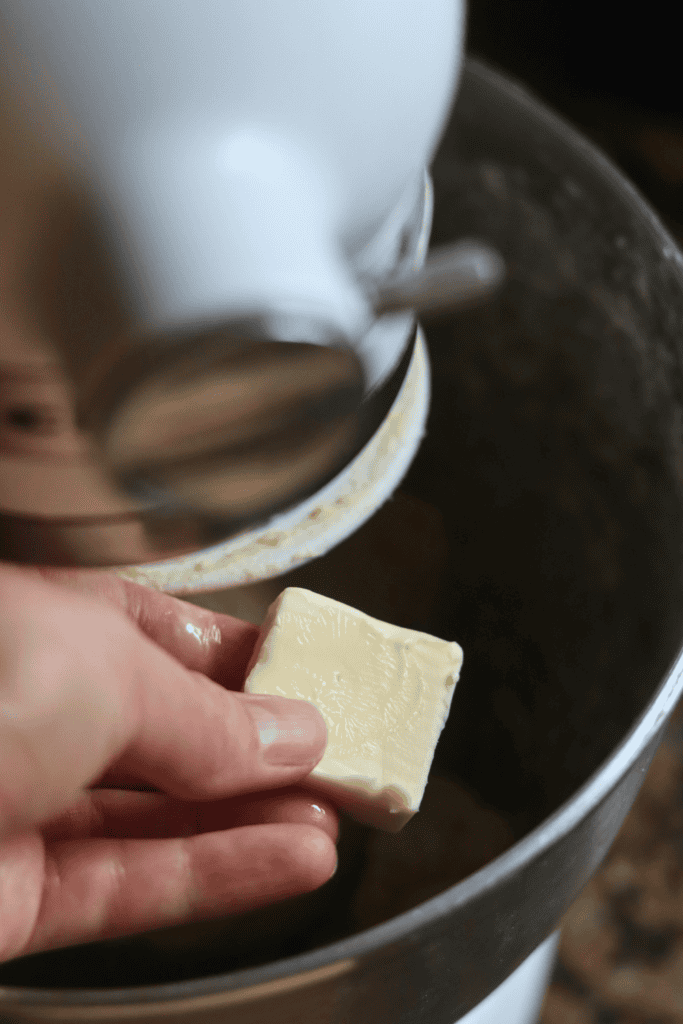 adding butter to the dough