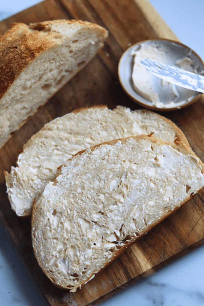 spreading mayo on one side on the sourdough bread