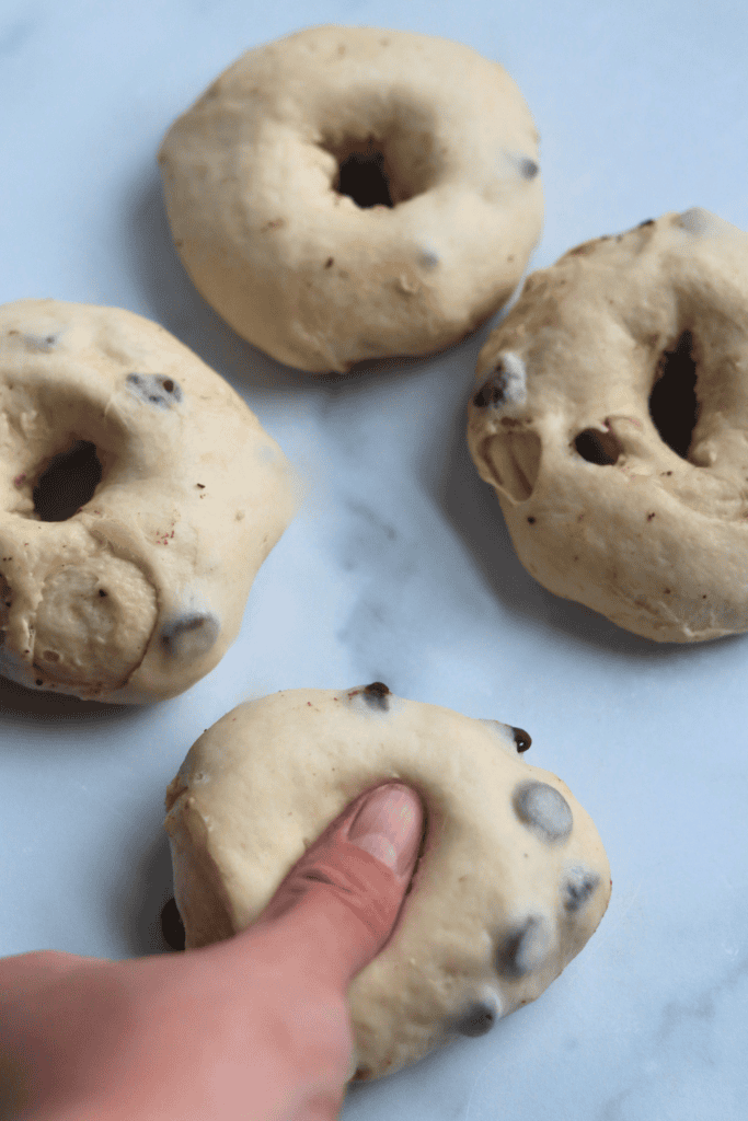 using thumb to poke a hole on the dough