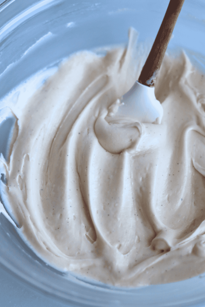  softened cream cheese, softened butter, maple syrup, and vanilla extract to the bowl of a stand mixer fitted with the paddle attachment.