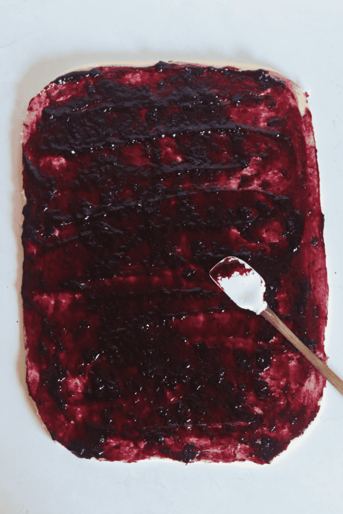 spread out blueberry on the dough