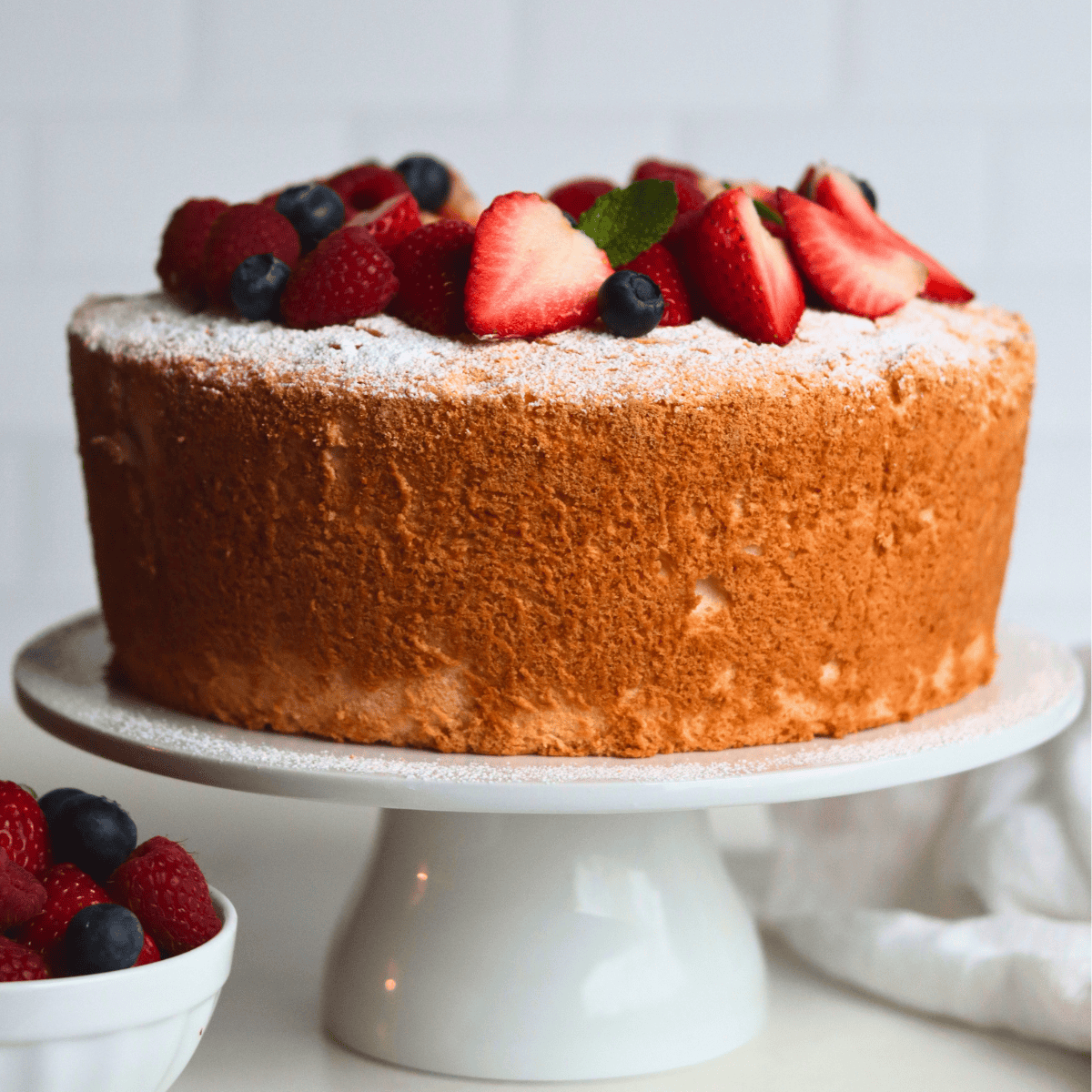 Sourdough Angel Food Cake on a cake stand