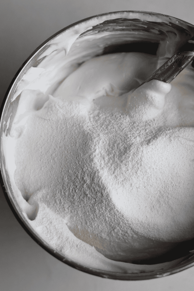 adding the sugar into the egg white mixture