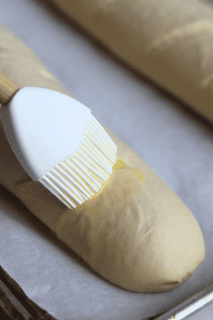 brushing the french bread with egg wash