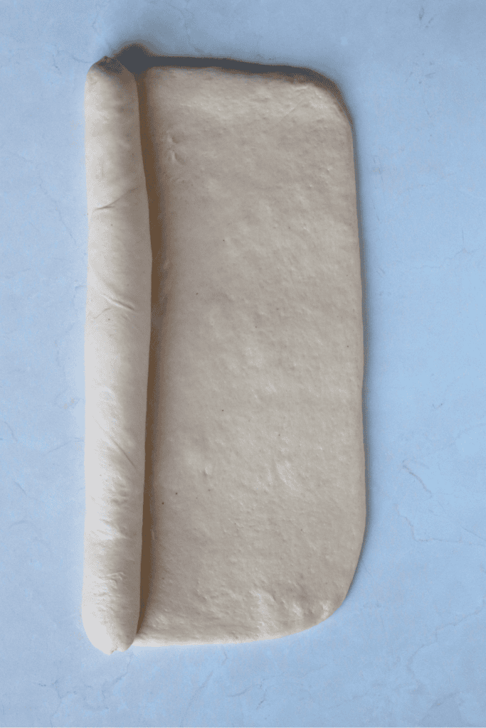 shaping dough into a french bread